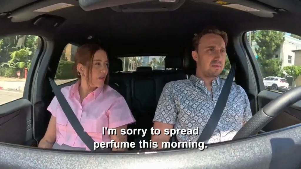 A man and a woman in a car, with the caption "I'm sorry to spread perfume this morning."