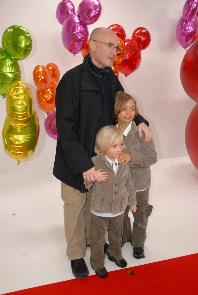 Phil Collins with sons Nicholas and Matthew at a Disneyland Resort Paris event.