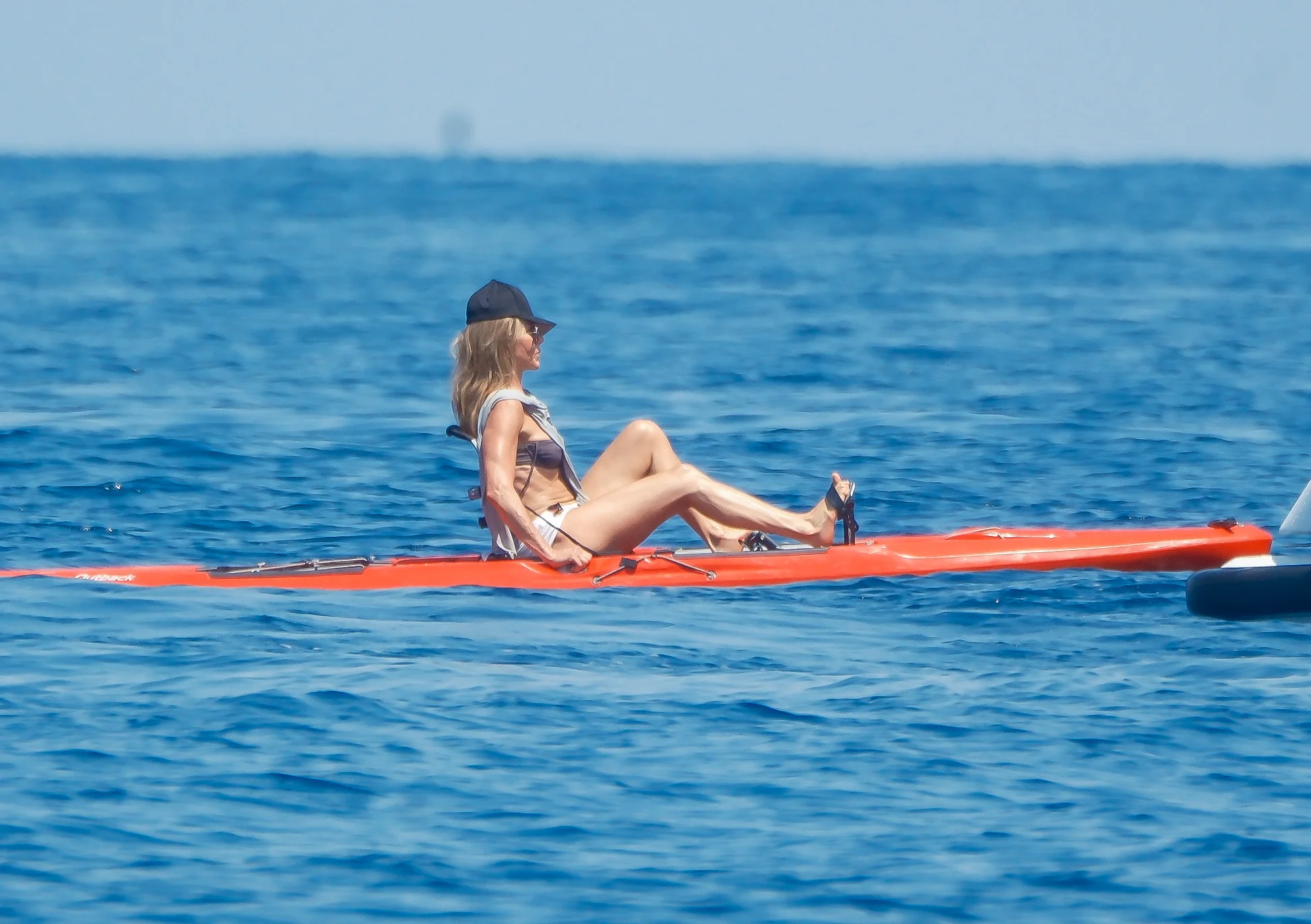 Jennifer Aniston paddle boarding in Mallorca.