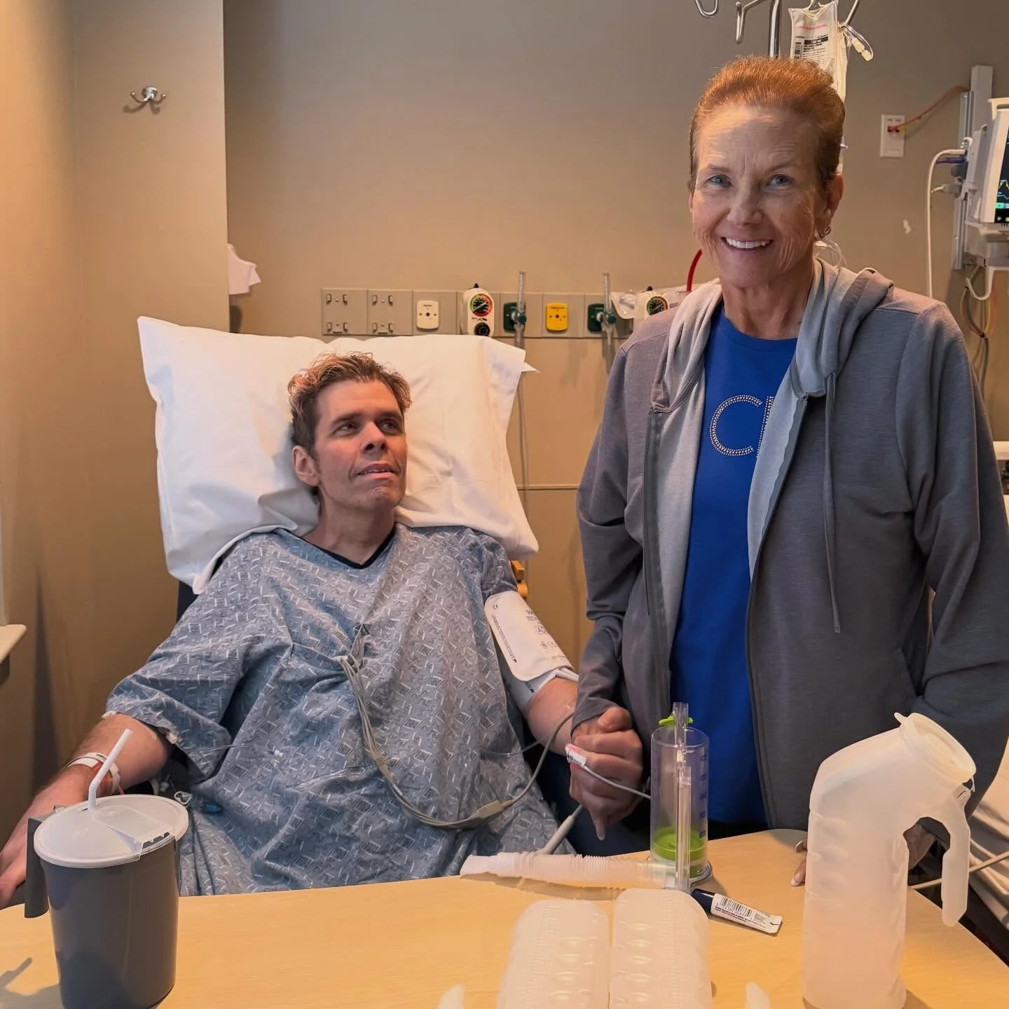 Perez Hilton and his mother Teresita in a hospital room.
