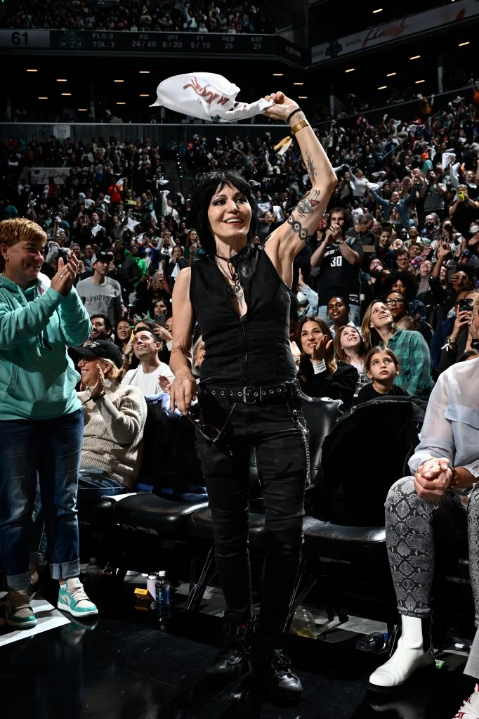 Joan Jett waves a white towel to the crowd during the WNBA Finals.