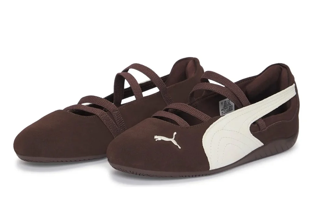 Pair of brown Puma shoes with white stripes and elastic straps.