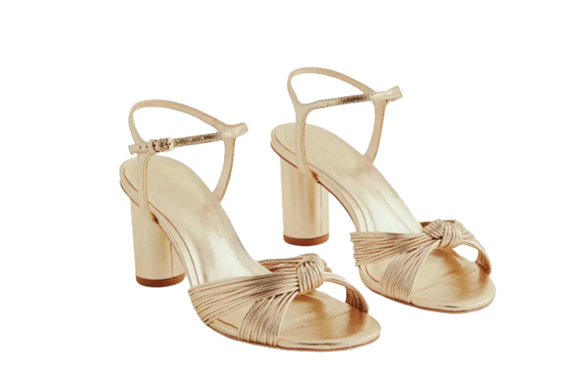 Pair of gold ankle-strap sandals with block heels and knotted straps across the toes.