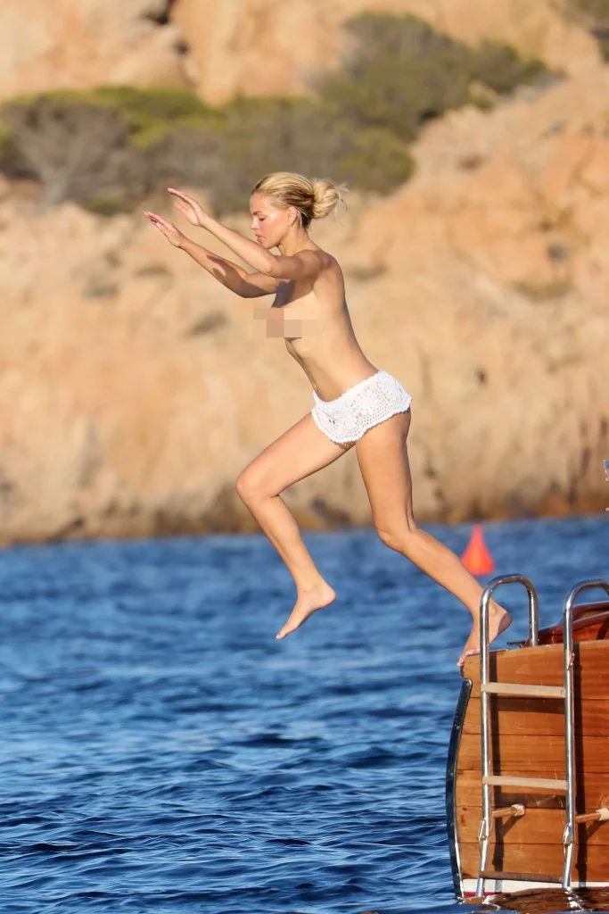 Brooks Nader jumping into the water from a boat while topless.