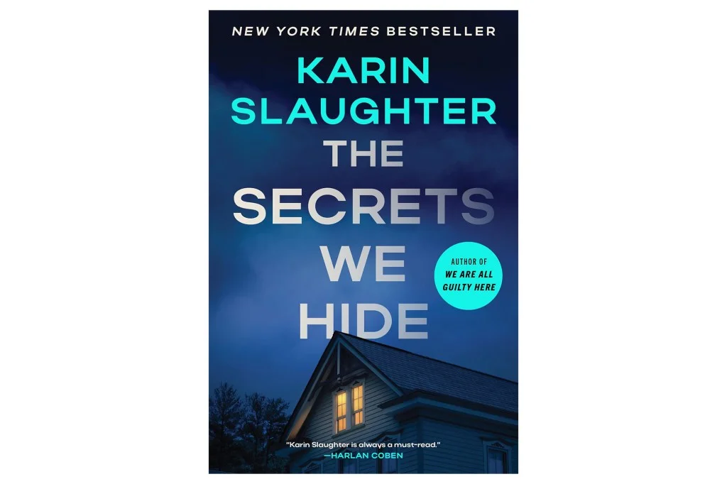 Book cover for "The Secrets We Hide" by Karin Slaughter, with a dark blue sky above a house with glowing windows.