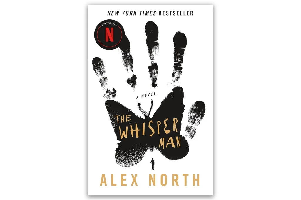 Book cover for "The Whisper Man" by Alex North, featuring a black handprint with a butterfly shape on the palm and a small figure below.