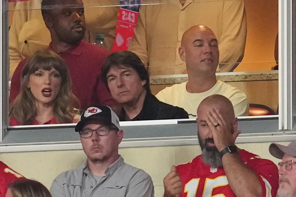 Taylor Swift and Tom Cruise watching a game at GEHA Field at Arrowhead Stadium.