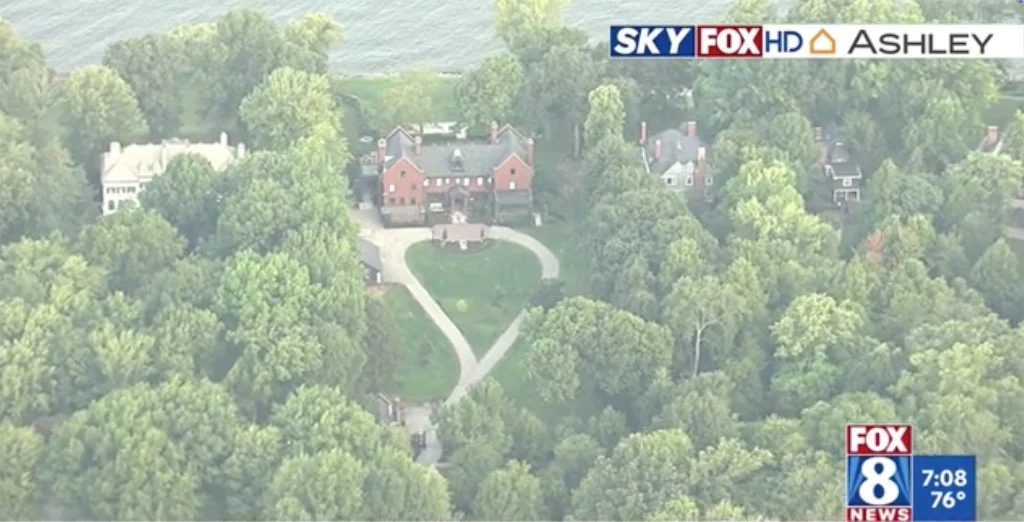 Aerial view of a large brick house surrounded by trees with a heart-shaped driveway, reportedly Taylor Swift and Travis Kelce's new Ohio home.