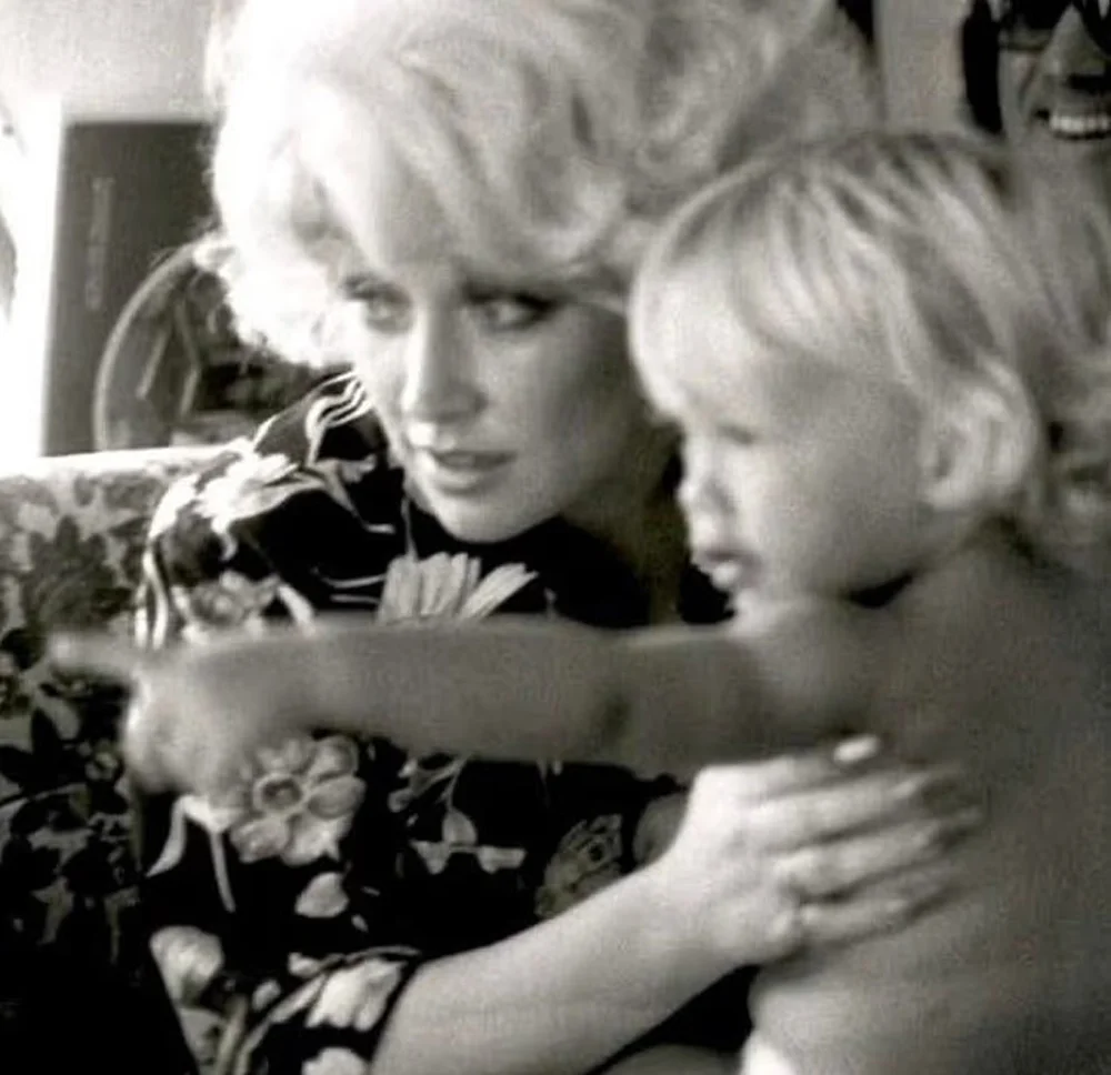 Dolly Parton with her nephew Bryan Seaver, who is pointing his finger.