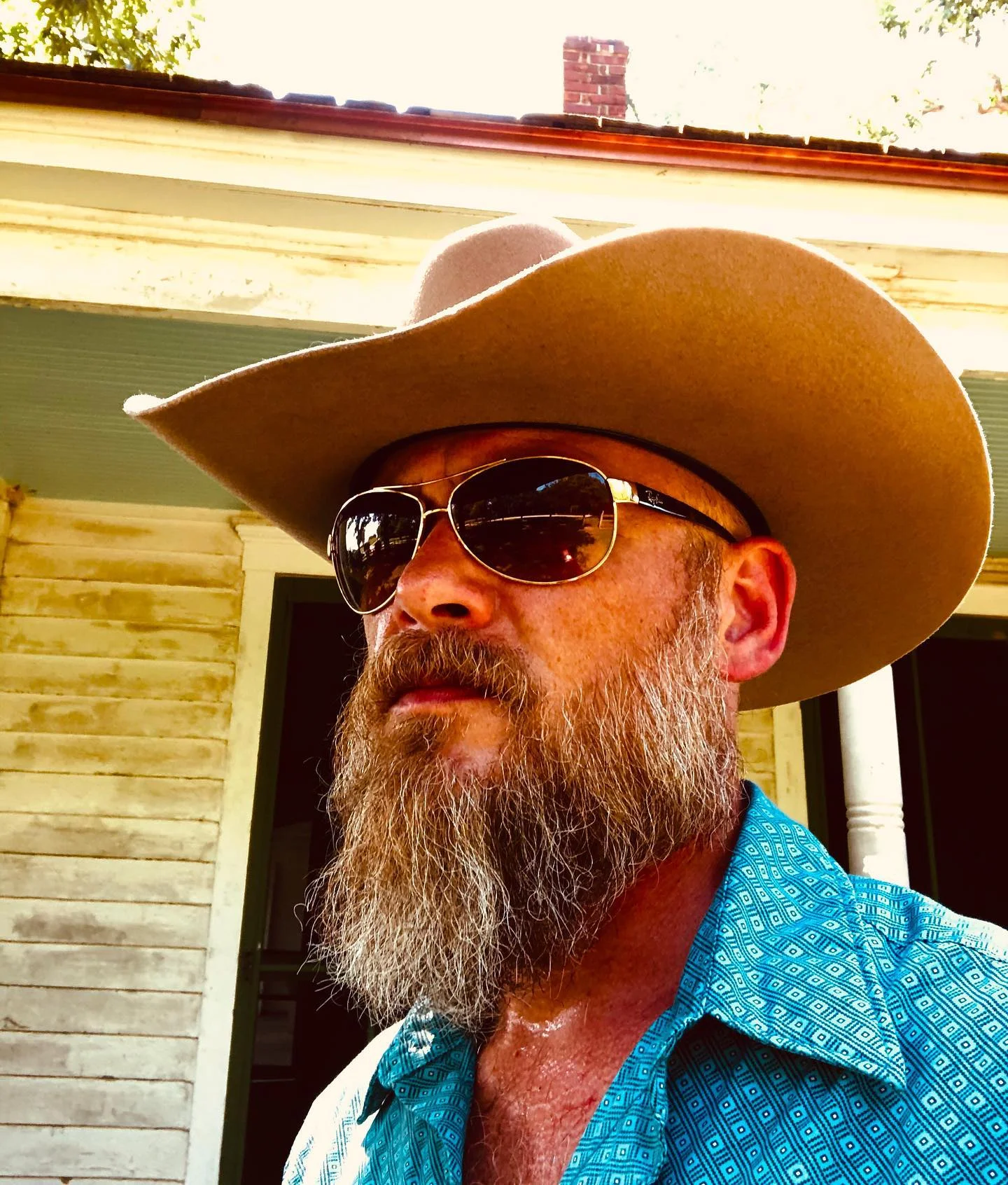 Bryan Seaver, Dolly Parton's nephew, in a brown cowboy hat and sunglasses.