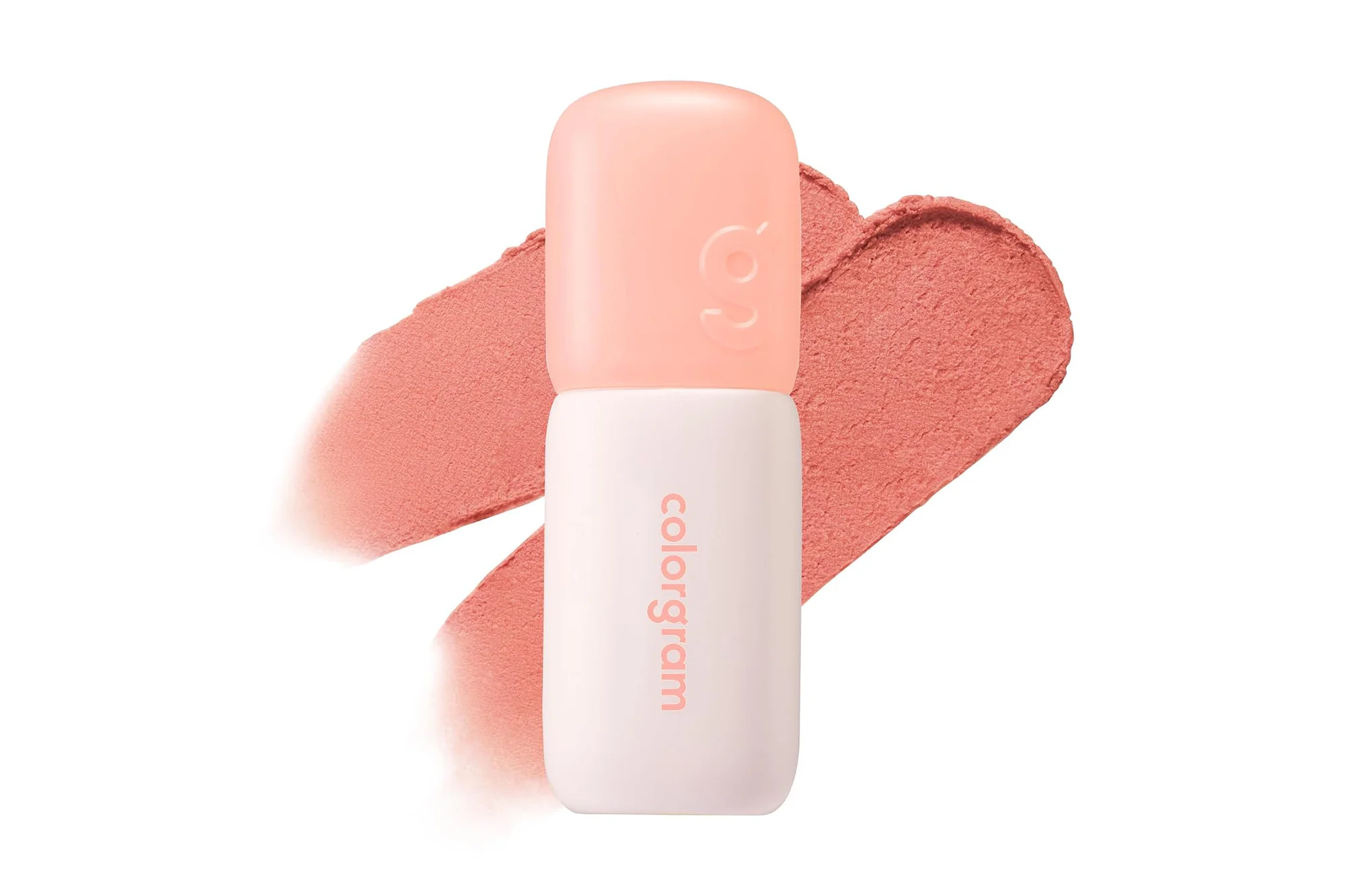 A Colorgram blush stick, light peach at the top and white on the bottom, with two coral blush swatches behind it.